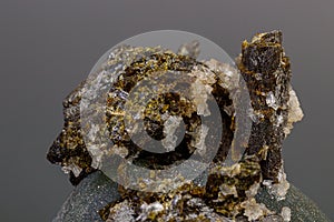 Macro mineral stone Prehnite on Epidote on a gray background