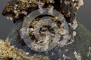 Macro mineral stone Prehnite on Epidote on a gray background