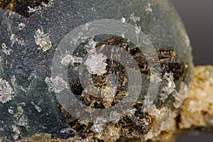 Macro mineral stone Prehnite on Epidote on a gray background