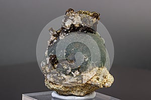 Macro mineral stone Prehnite on Epidote on a gray background