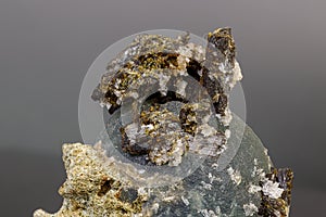 Macro mineral stone Prehnite on Epidote on a gray background