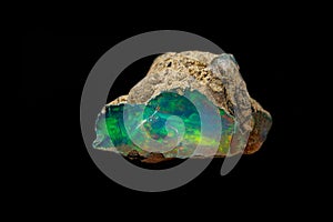 Macro mineral stone rare and beautiful opals on a black background