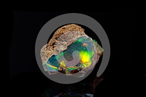 Macro mineral stone rare and beautiful opals on a black background