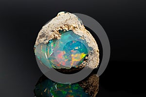 Macro mineral stone rare and beautiful opals on a black background