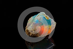 Macro mineral stone rare and beautiful opals on a black background