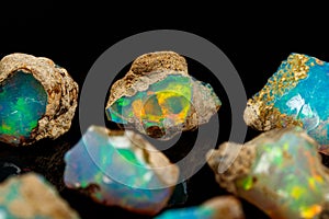 Macro mineral stone rare and beautiful opals on a black background