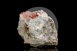 Macro of the mineral stone Rhodochrosite with fluorite on a black background