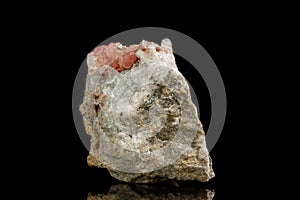 Macro of the mineral stone Rhodochrosite with fluorite on a black background