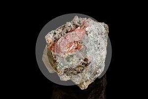 Macro of the mineral stone Rhodochrosite with fluorite on a black background