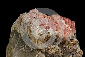 Macro of the mineral stone Rhodochrosite with fluorite on a black background