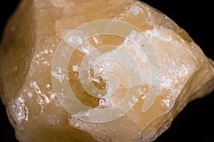 Macro mineral stone yellow calcite on white background