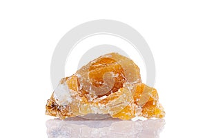 Macro mineral stone yellow calcite on a white background