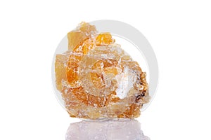 Macro mineral stone yellow calcite on a white background
