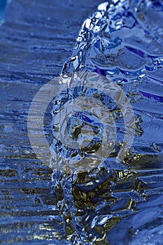 Macro modern art texture of bright abstract crystal glass reflecting brilliant blue color with a look of ice crystals or rock
