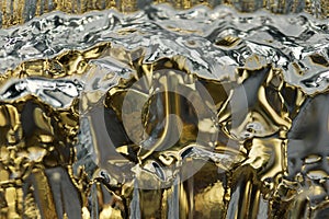 Macro modern art texture of bright abstract crystal glass reflecting brilliant golden color with a look of ice crystals or rock