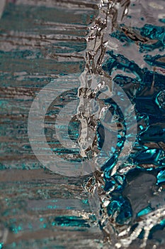 Macro modern art texture of bright abstract crystal glass reflecting brilliant turquoise and silver color