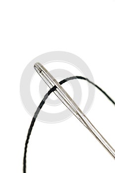 Macro of needle eye and threaded sewing