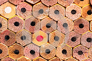 A macro OCD very orderly stack of new #2 unsharpened pencil ends with triggering Red and White colored pencils in the stack