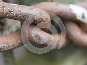 Macro of old rusty thick iron chain link, selective focus. connection or joinning concept