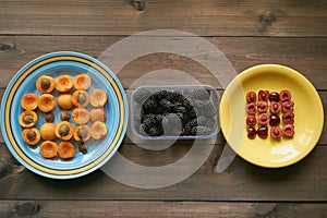 Macro pattern from apricots and cherries on a plates