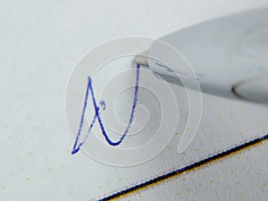 macro pen and handwritten signature on white paper, selective focus. Contract conclusion concept