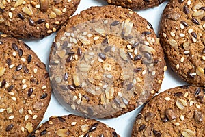 Macro photo of brown dietary low-calorie fitness cereal biscuits with sprinkling closeup on white background