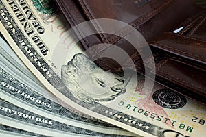 Macro photo. Brown leather wallet with money us dollars inside it