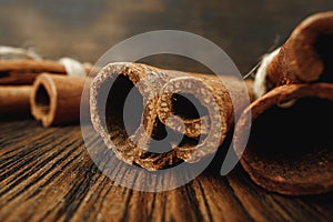 Macro photo of cinnamon sticks on wooden background