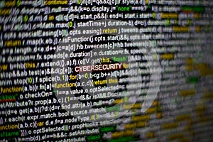 Macro photo of computer screen with program source code and highlighted CYBERSECURITY inscription in the middle. Script
