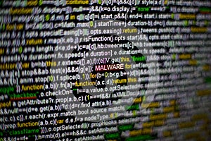 Macro photo of computer screen with program source code and highlighted MALWARE inscription in the middle. Script on the