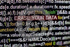 Macro photo of computer screen with program source code and highlighted SPYWARE inscription in the middle. Script on the