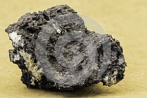 Macro photo of a dark mineral specimen showing fibrous structure and metallic sheen. Useful for geology, earth science, mineralogy photo