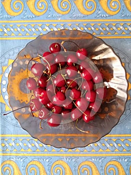 macro photo with a decorative background of red cherry fruits on a plate for design