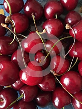 Macro photo with a decorative background of a still life with a harvest of red fruits from a cherry tree for design