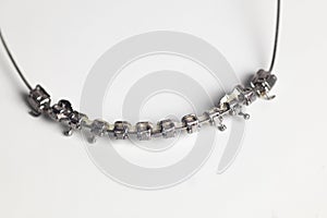 Macro photo of dental braces without teeth, dismounted from mouth, nobody on the picture. Dental braces with arch, wires, springs