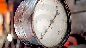 Macro photo of dial and pointer on retro manometer at steam power engine