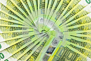 Macro photo of the European Union 100 EURO banknote, bills arranged in a fan, isolated on a white background, top view.