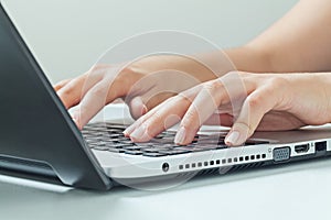 Macro photo of female hands typing on laptop. businesswoman work