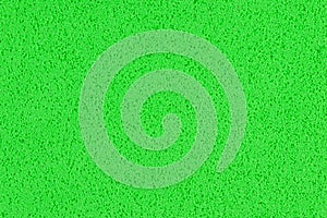 A macro photo of a green gradient color with texture from real foam sponge paper for background, backdrop or design.