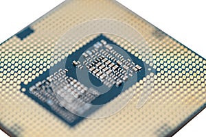 A macro photo of a modern CPU processor under the LGA 1200 socket on a green circuit board, isolated on a white background.