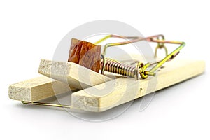 Piece of kabanosa meat lying on a pawl in a mousetrap, isolated on a white background. photo