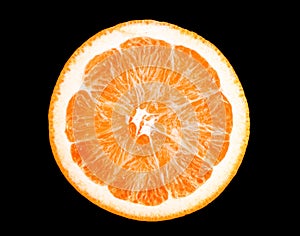 Macro photo of slice of orange fruit isolated on black background