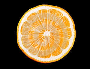 Macro photo of slice of orange fruit isolated on black background