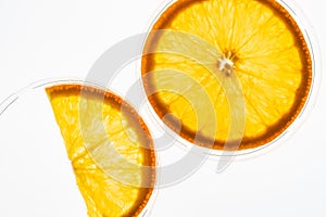 Macro photo of slices of ripe juicy orange with back light isolated on white background. Top view
