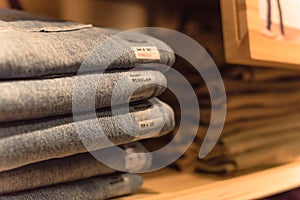 Macro photo stack of blue jeans at casual clothing shop in America