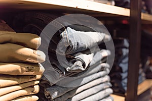 Macro photo stack of blue jeans at casual clothing shop in America