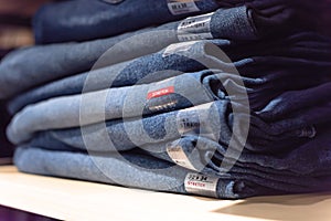 Macro photo stack of blue jeans at casual clothing shop in America