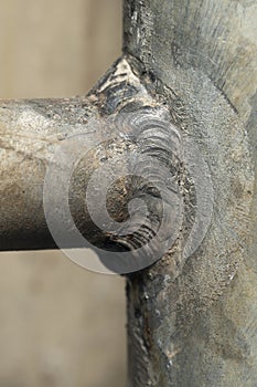 Welded seam at the junction of two welded water pipes macro