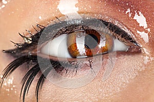 Macro photo of wman eye with wet make up