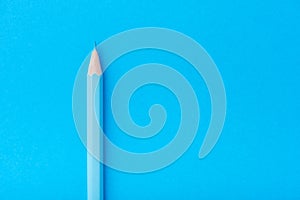 Macro photograph of several pencils of blue color on a paper background